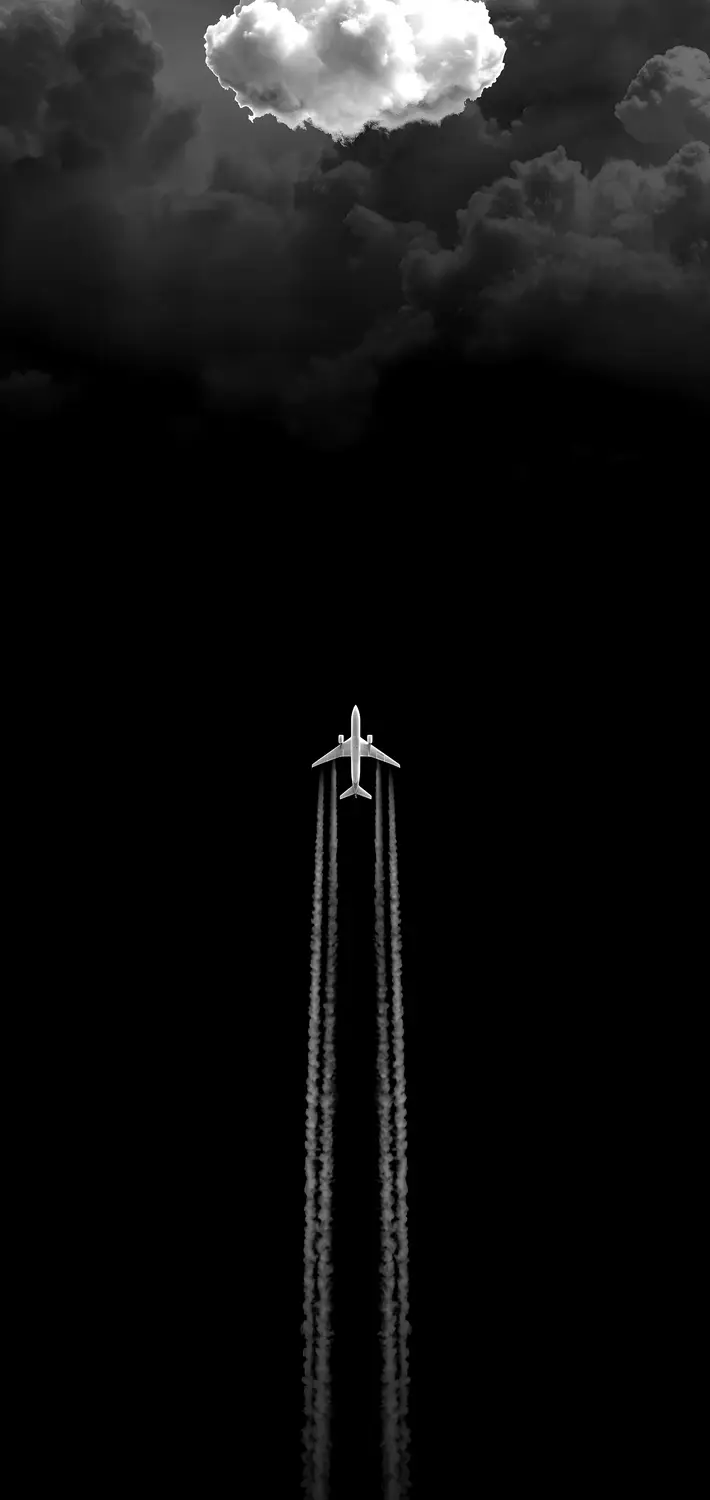 An aircraft climbing through dark sky